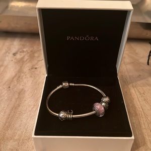 Pandora Bracelet. Never been worn. Comes in original box with 5 charms